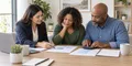A Maryland couple comparing health insurance costs with an insurance professional