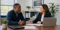 A Maryland consumer reviewing health coverage options after a job loss with an insurance agent