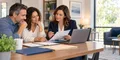A couple reviewing an organized life insurance policy checklist with an insurance professional