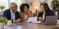An older Maryland adult and family member organizing Medicare coverage questions with a licensed insurance agent